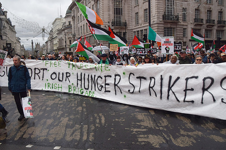 Protesters hold a banner in support of the Palestine Action activists who are part of the group known as the 'Filton 24', who were arrested following a protest action at a facility owned by arms manufacturers Elbit Systems and who are currently on hunger strike, during the demonstration in Piccadilly as thousands of people march in support of Palestine.