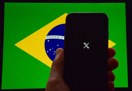 In this photo illustration, an X logo seen displayed on a smartphone with a flag of Brazil in the background. The supreme court in Brazil has ordered the suspension of Elon Musk's social media platform X, formerly Twitter, after the company failed to appoint a legal representative in the country before the deadline. Judge Alexandre de Moraes had previously ordered the platform to suspend accounts which are accused of spreading disinformation, which Musk has described as "censorship".