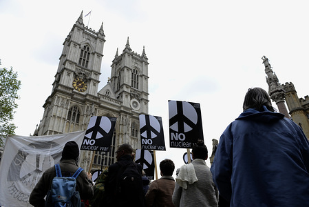 Activists are seen holding placards during the protest.
Anti-nuclear activists gathered opposite Westminster Abbey in London to protest against a service of thanksgiving organised by The Royal Navy to mark 50 years of Britain's submarine-based nuclear weapons. Anti-nuclear activists performed a “die-in” outside Westminster Abbey representing the victims of nuclear war.