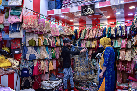 A Kashmiri woman shops cloths ahead of Muslim festival Eid al-Fitr at a local market in Srinagar. Markets across the Muslim world witness huge shopping rush in preparation for Eid al-Fitr, a celebration that marks the end of the Muslim fasting month of Ramadan.