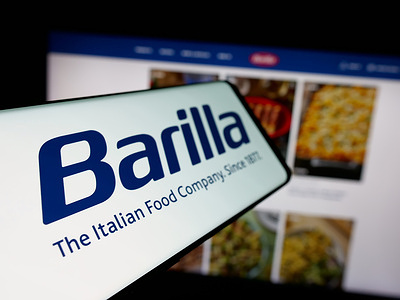 In this photo illustration, a smartphone with the logo of Italian food processing company Barilla is seen on screen in front of website.