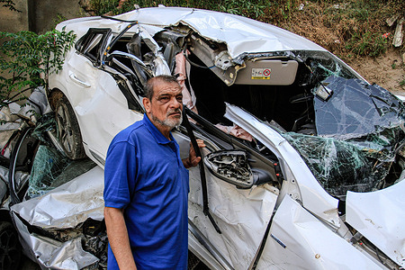A Palestinian inspects wrecked cars destroyed by Israeli military vehicles during the second consecutive day of the Israeli military forces raid on the Jenin refugee camp in the northern West Bank.