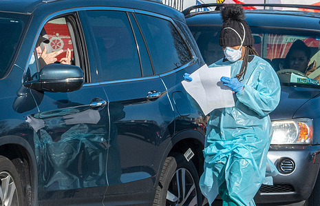 A man crosses his fingers while a health worker returns to his vehicle after being tested at a drive-thru testing site.
A week long Covid-19 drive-thru testing site has been set up in Wilkes-Barre. Each day 500 tests can be administered at the drive-thru. The site was closed early on Tuesday after more individuals went to get tested.