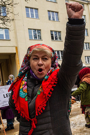 A member of the Mushroom Picking Club raises her fist in the air during a demonstration. On the afternoon of the 13th of February, women of the "Rydz" Mushroom Collecting Club and their activist friends from Warsaw join a demonstration outside the Ministry of Climate and Environment to defend the Bieszczady forests. For two years, two Bieszczady forest districts, Lutowiska and Stuposiany, have been cutting down the Carpathian forests without an approved Forest Management Plan. Despite a ministerial moratorium, foresters in most of these areas have planned felling within the next 10 years. Foresters want to cut over 90% of the area of ​​these two forest districts. This is unacceptable for Poland's traditional mushroom pickers. Protesters wear traditional Polish attire and carry mushroom baskets. They make speeches, dance, and hold placards and banners.