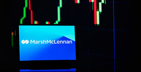 In this photo illustration, the Marsh McLennan logo seen displayed on a tablet.