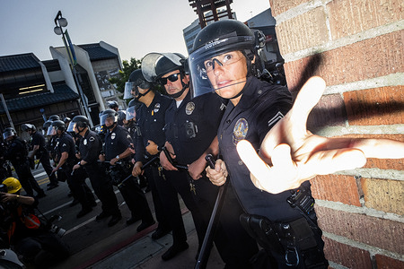 Police stand in offense against protestors during the demonstration. U.S. Immigration and Customs Enforcement (I.C.E.), Get Out Of Los Angeles protest in Downtown Los Angeles, where protestors gather to demand that I.C.E. agents stop detaining and arresting migrants.