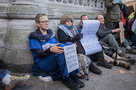 Palestinian protestors hold up placards in support of the proscribed group Palestine Action. Palestine Action protestors were once again arrested under the Terrorism Act for holding up signs in support of the proscribed group. The mass action outside the Royal Courts of Justice was coordinated to coincide with the judicial challenge of the proscription of Palestine Action which starts this week.