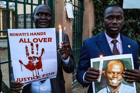 Activists hold candles and posters to pay tribute to the assassinated Eswatini, formerly Swaziland, Human Rights Lawyer Thulani Maseko in Nakuru Town. Human Rights Lawyer Thulani Maseko laid to rest on Sunday, January 29, 2023, was brutally killed in front of his wife and two young children by unknown assailants at his home in Luhelko. He was famously known for agitating for the ending of absolute monarchy in Eswatini, formerly Swaziland.