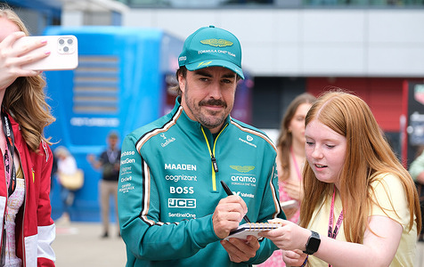 Fernando Alonso of Aston Martin Aramco F1 Team signs autographs during the Formula One British Grand Prix at Silverstone. Lando Norris of McLaren Formula 1 Team won the British Grand Prix.