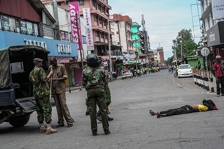 (EDITORS NOTE: Image depicts death) 
Police officers stand beside a lifeless body of a man that was ran over by a police car lies on the tarmac during an industrial strike against the recent increase in fuel prices. Prices of diesel and petrol rose sharply last week, with the government citing supply constraints linked to the ongoing conflict in the Middle East.