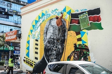 An artist paints a mural of the late President Mwai Kibaki to commemorate Kenya’s 2010 Constitution. President William Ruto officially designated August 27 as Katiba Day, a national day marking the Constitution’s adoption.