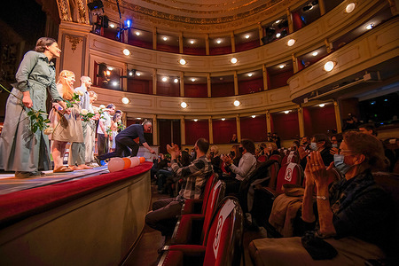 People wearing face masks as a precaution against the spread of covid-19 applaud actors after the play 'Cat on a Hot Tin Roof' at the Slovene National Theatre.
This is the first play after more than six-month of coronavirus closure. As Slovenia reaches the "Yellow phase" the Slovenian government has relaxed some of the COVID measures. Under strict conditions Cultural events are allowed again. Participation of up to 50 persons under condition of RVT (recovered, vaccinated, tested) and seating places with distance can be 50 per cent occupied.