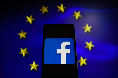 Facebook logo is seen in an Android mobile with European Union flag on the background.