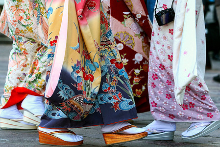 Japanese women seen wearing colorful kimonos gather to celebrate Coming of Age Day commemorating their entrance into adulthood.