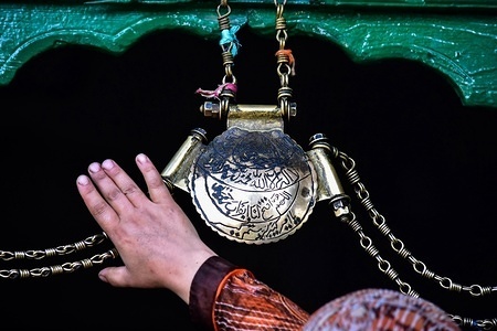 A Kashmiri woman seen touching an ornament engraved with verses from the Quran at the shrine during the special prayers.
The 653rd death anniversary of sufi saint Mir Syed Ali Hamadani, popularly known as Shah-e-Hamdan, was observed across Kashmir with devotees thronging Mosques and shrines for special prayers. The biggest congregation was held at Khanqah-e-Moula in old Srinagar city with religious fervor and enthusiasm.
