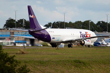 A FedEx Boeing 737-400Sf about to leave a Liege Bierset airport full of packs to deliver.