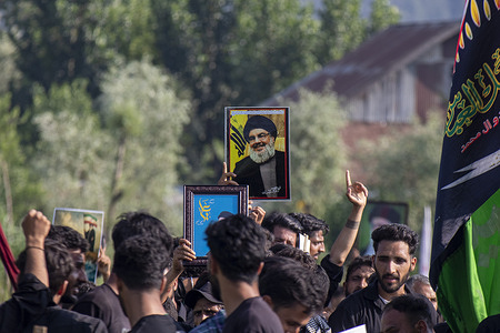 Kashmiri Shiite mourners hold a portrait of late Hizbollah chief Hassan Nasrallah as they move on boats during the procession in the interiors of Dal lake in Srinagar on the 9th of Muharram, the first and holiest month the Islamic calendar. Shiite Muslims commemorate Muharram as a month of mourning in remembrance of the martyrdom of Islamic Prophet Muhammad's grandson Imam Hussain, who was killed along with his family members on Ashura (the 10th day of Muharram) in the battle of Karbala in southern Iraq in 680 A.D.