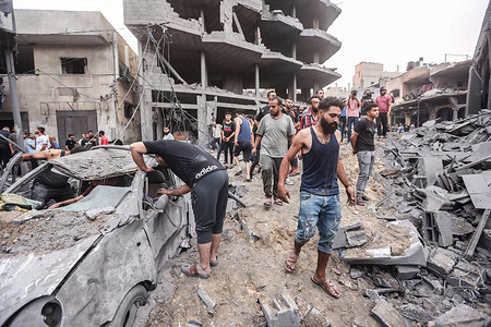Palestinians inspect damaged buildings in the aftermath of Israeli strikes, following a Hamas surprise attack, at Beach refugee camp, in Gaza City. Israel imposed a total siege on the Gaza Strip on October 9 and cut off the water supply as it kept bombing targets in the crowded Palestinian enclave in response to the Hamas surprise assault it has likened to the 9/11 attacks.
