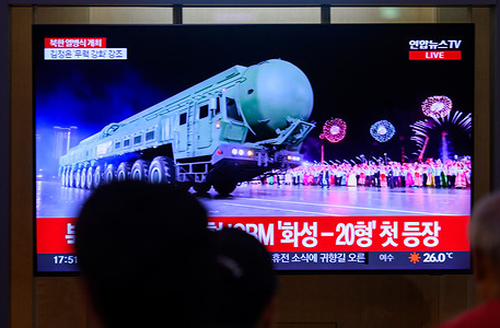 People look at a 24-hour Yonhap news TV broadcast at Seoul Railway Station showing a news broadcast with a Hwasong-20 Intercontinental Ballistic Missile (ICBM) display during a military parade marking the 80th anniversary of the founding of North Korea's ruling Workers' Party of Korea at Kim Il Sung Square in Pyongyang. North Korea has showed off its newly developed Hwasong-20 intercontinental ballistic missile (ICBM) for the first time, among other new weapons, at a military parade to mark the 80th anniversary of the founding of its ruling Workers' Party of Korea.