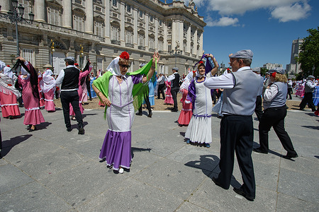 People seen dancing along the streets during a traditional parade, a popular event during the San Isidro Festival at Puerta del Sol.