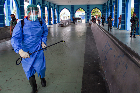 A member of the Indonesian Army dressed in a protective suit while spraying disinfectants in public places and places of worship as a preventive measure against the spread of Coronavirus in Lhokseumawe.According to the Indonesian government report, cases of the Coronavirus continued to increase. 2020, 893 people tested positive, 78 dead and 35 recovering.