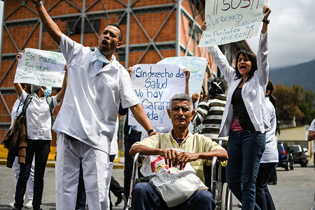 Protester seen with placards during the demonstration.
National protest in the health sector for lack of medicines and demanding an increase in salaries. The protest was called by the health association (FETRASALUD in spanish) at the national level. Doctors and staff working in hospitals protested in front of each health center demanding an immediate solution to the crisis affecting the public health system in Venezuela