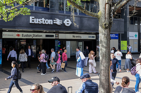 An exterior view of London Euston Station with people around the place.