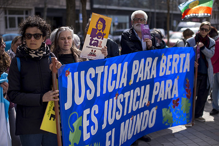 Activists hold a banner that reads in Spanish, "Justice for Berta is justice for the world," during a rally in front of the Honduran embassy. Ten years after her assassination, Berta Caceres, an indigenous Lenca leader, feminist, and environmentalist, was murdered for her opposition to the Agua Zarca hydroelectric dam on the night of Wednesday, March 2, 2016, at her home in Honduras. In 2015, Berta Caceres received the Goldman Environmental Prize.