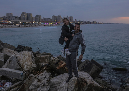 Palestinian men seen enjoying themselves at the Gaza beach during sunset in western Gaza City.