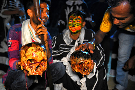 Hindu devotees with human skulls seen during the night ritual of Gajan festival . Gajan associated with gods as Shiva, Neel and Dharmathakur. It is spans around a week, starting at the last week of Choitro continuing till the end of the Bengali year. Participants of this festival are known as sannyasi or Bhokta. The central theme of this festival is deriving satisfaction through non-sexual pain, devotion and sacrifice.
