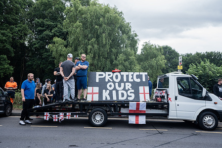 A large placard appealing to the government to "Protect our Kids" is parked outside the Bell Hotel in Essex during the rally. Large crowds of anti-immigration protesters clashed with police trying to keep them separated from anti-hate counter-protesters outside The Bell Hotel in Epping, Essex. The altercation followed accusations of a recently-arrived Ethiopian asylum seeker’s involvement in three cases sexual assaults. Anti-immigration demonstrators are urging the Home Office to close the hotel, which currently houses asylum seekers.