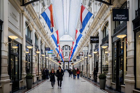 National flags seen in Passage shopping center on King's Day in city of The Hague in Netherlands. Koningsdag or King's Day is a national holiday in the Kingdom of the Netherlands. Celebrated on 27 April, the date marks the birth of King Willem-Alexander. The Passage in The Hague is the oldest existing shopping center in the Netherlands.