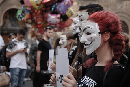 Participants are seen wearing anonymous masks while holding placards during the protest.
Anonymous is a vegan activist group wearing black clothes while holding laptops and placards as they demonstrate against exploitation of animals, The Cube of Truth is a peaceful static demonstration akin to an art performance.