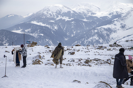 Indian Border Security Force Personnel seen when the Indian tourists gathered on snow covered slopes on the Eve of New Year at Apharwat Peak.