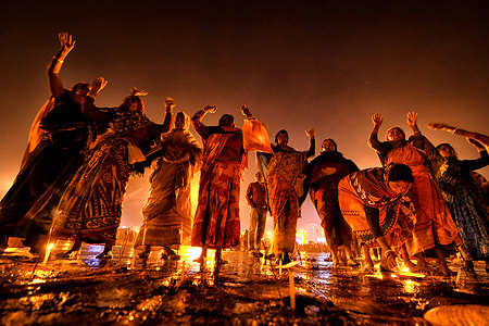 Hindu Women seen praying at the beach of Gangasagar during evening time as per traditional Ritual. Gangasagar is one of the religious places for Hindu Pilgrims situated at the Bay of Bengal where every year millions of devotees come to take a Holy bath during Makar Sankranti (Transition of Sun) as per Hindu calendar and offer prayers to Kapil Muni Temple. The date for this Festival usually falls between 13 to 15 January of every year.