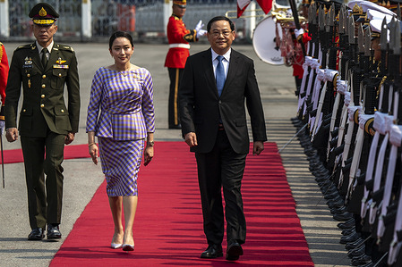 Laos Prime Minister Sonexay Siphandone (R) and Thai Prime Minister Paetongtarn Shinawatra (L) review the guard of honor during a welcoming ceremony at Government House.
