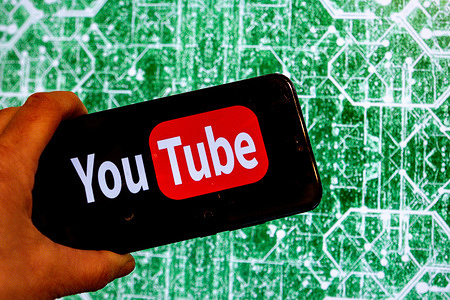 In this photo illustration, the YouTube logo is shown on a smartphone screen.