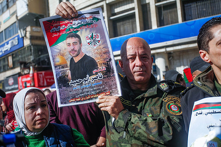 A Palestinian protester chants slogans while holding a portrait of late captive Nasser Abu Hmeed, during the demonstration in the West Bank city of Nablus. During the protest, demonstrators claim that Nasser Abu Hmeed died of an illness due to medical negligence in an Israeli prison. Nasser Abu Hmeed was sentenced to life imprisonment in an Israeli jail.