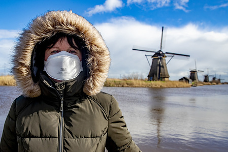 A woman looks on while wearing a protective mask amid Coronavirus fears in Kinderdijk. Ten people has been infected with the Covid 19 (coronavirus) in the Netherlands since 27 February 2020.