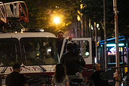 Actor Gerard Butler steps out of an FDNY fire engine during filming. Production is underway for the upcoming film Empire City as Melbourne Town Hall is transformed into a slice of New York City. NYPD patrol cars, a genuine FDNY fire engine and carefully detailed New York themed props dramatically reshape the streets.