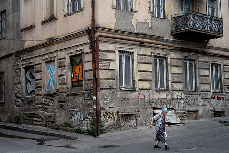 An elderly Georgian lady seen crossing the streets in downtown neighborhood of Old Tbilisi.