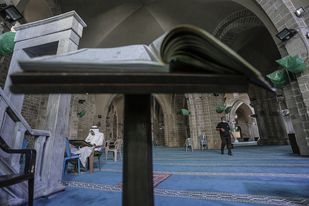 A Muslim man seen reading the Holy Quran at the historic, medieval Grand Mosque in Gaza City during Ramadan.
Muslims around the world celebrate the blessed month of Ramadan by praying during the night and abstaining from eating, drinking and sexual practices during the period between sunrise and sunset. Ramadan is the ninth month in the Islamic calendar and it is believed that the first Quranic verse was revealed during its last ten nights.