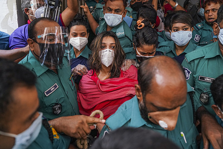 Police officers wearing facemasks seen arresting JKG Health Care Chairman Dr. Sabrina Sharmin Hussain (In Red).
Police officers wearing facemasks seen arresting JKG Health Care Chairman Dr. Sabrina Sharmin Hussain (In Red).
JKG Health Care Chairman Dr Sabrina Sharmin Hussain was held on a three-day remand in a case filed over issuing fake Covid-19 test certificates.