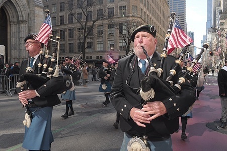 A band of bagpipers march at the New York City St. Patrick's Day Parade outside of St. Patrick's Cathedral on Fifth Avenue. The annual parade commemorating Irish culture, draws police officers, firefighters, politicians, bands and revelers to midtown Manhattan, New York City.