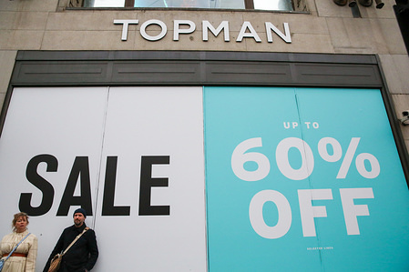 A couple are seen standing in front of a large SALE sign at the Topman store window on London's Oxford Street.
Last minute Christmas shoppers take advantage of pre-Christmas bargains at Oxford Street in London. Fewer shoppers have been reported shopping in Britain's high streets as online sales increase.