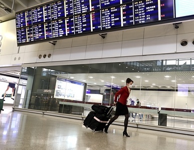 A flight attendant wearing mask at the arrival hall in the Hong Kong international Airport

Since the outbreak of the Corona Virus epidemic in Wuhan, China, concerns have risen about how the virus might be spread by air travelers. Flight attendants and pilots are now wearing face masks and fewer people are traveling for fear of catching the virus. The airport in Hong Kong is much quieter than usual.