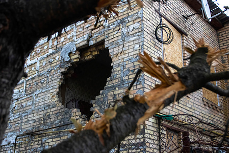 A home and tree damaged by a Russian missile. Russian forces continue their full scale invasion in Ukraine. Damage to civilian buildings in Boyarka from Russian missile strike.