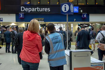 A South Western Railway (SWR) staff member assists the affected members of the public during the strike.
Industrial action taken by the National Union of Rail, Maritime and Transport Workers (RMT) scheduled over five days has affected passengers traveling from Waterloo via South Western Railway (SWR) services to Ascot, where Britain's most prestigious horse racing meeting, Royal Ascot began on Tuesday. Passengers are advised to allow additional time for the journey.