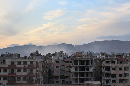 Smoke seen rising from the city of Harasta as a result of shelling by the regime forces.
The shelling of the city comes from the mountains overlooking Ghouta which are under regime control.