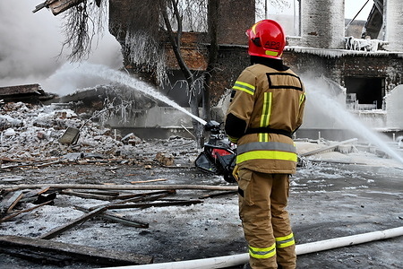 A firefighter works at the site of a building that was hit by a Russian drone, amid Russia's attack on Ukraine.